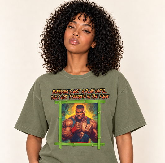 Everyone's Got A Plan Until They Get Punched In The Face – Relaxed Heavyweight Tee — Moss, existing Treattees model, direct crop, original print unchanged